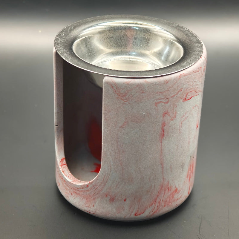 Brûleur à fondants parfumés cylindrique en composite minéral couleur gris marbré rouge, avec ouverture frontale et coupelle en inox