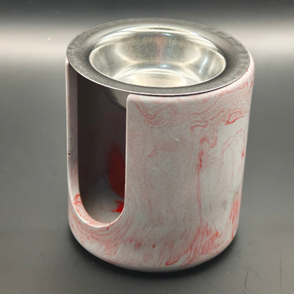 Brûleur à fondants parfumés cylindrique en composite minéral couleur gris marbré rouge, avec ouverture frontale et coupelle en inox